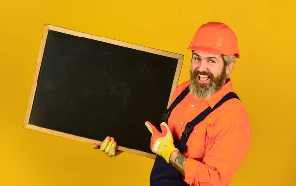 Repair company services. Architect demonstrating project. Professional repairman. Visual outline. Bearded man repairman builder. Repairman hold blackboard copy space. Handsome repairman. Price list