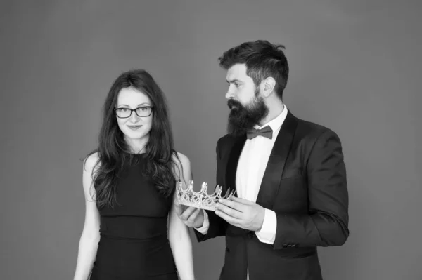 Awarding ceremony. Prom couple. Couple in love red background. Couple of sensual woman and bearded man with crown. Business couple in formalwear. Ceremonial reception. Holiday celebration — Stock Photo, Image