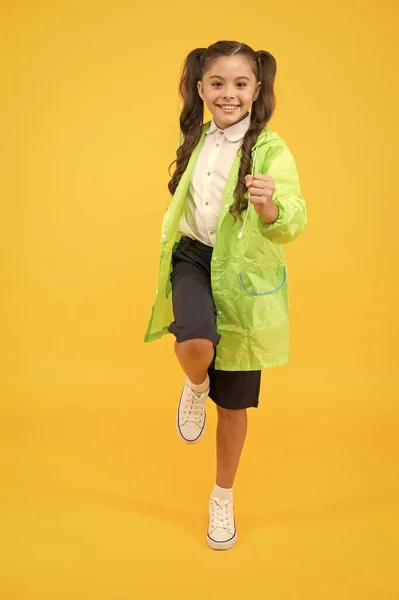 Desfrutar de chuva de outono. descontos incríveis. menina pequena se divertir em capa de chuva. estudante ativo manto impermeável. roupas resistentes à água. de bom humor. Acessório à prova de chuva. Moda de outono de crianças — Fotografia de Stock