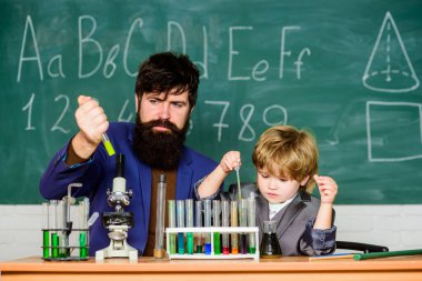 Powering Whats Next. small boy with teacher man. son and father at school. Modern Laboratory. Back to school. Biologist Conducts Experiments by Synthesising Compounds clipart