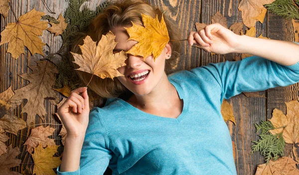 Lost in thoughts. Sharing love to nature. Staying beautiful any season. autumn female fashion. Carefree and happy. woman hold maple leaf. canada. girl on autumn background. Beauty in autumn style