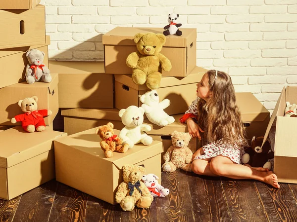 Playroom concept. Moving in. Delivering service. Feeling good at home. All she needs are toys. Home is where are my toys. Teddy bear collection. Sweet home. Girl child relaxing after unpacking boxes — Stock Photo, Image