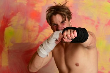 Siyah kimono kemerli ve kollarında bandaj olan adam.