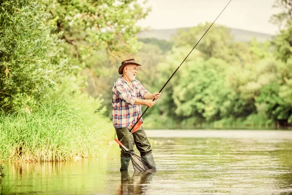 Mature man fishing. Male leisure. Fisherman with fishing rod. Happiness is rod in your hand. Retired fisherman. Senior man catching fish. Activity and hobby. Fishing freshwater lake pond river — Stock Photo, Image