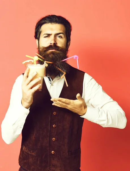 Serious handsome bearded man on red studio background — Stock Photo, Image