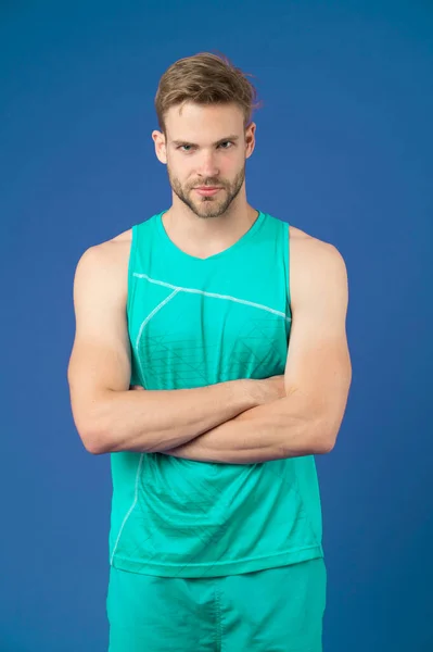 Fiers d'être forts. Tenue sportive homme semble grave et strict avec les bras croisés, fond violet. Un corps musclé fier de sa forme. Sportsman profiter de son corps musclé fier de lui-même — Photo