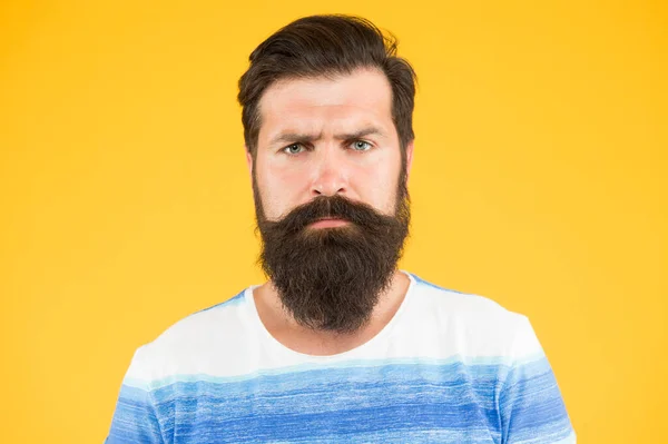 Be serious. Hipster appearance. Beard fashion and barber concept. Man bearded hipster stylish beard and mustache yellow background. Barber tips maintain beard. Stylish beard and mustache care — Stock Photo, Image