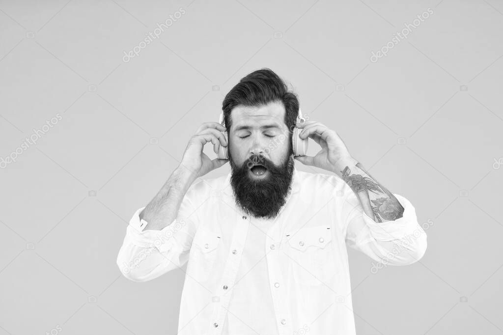 Hearing problem. Bearded man headphones. Modern wireless headphones. Dance music tracks. Ears health. Loud music. Active Noise Cancellation Technology. Hipster listen music stereo headphones