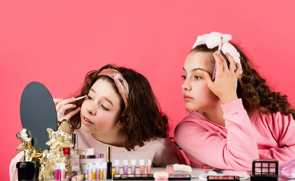 Cosmetics for children. Spa party. Sisterhood happiness. Skin care. Prevent acne. Kids makeup. Beauty and fashion. Happy girls doing makeup together. Beauty salon. Play with cosmetics. Cosmetics shop