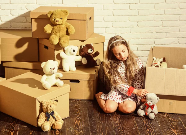 For what you leave behind. playing into new home. new apartment. happy little girl with toy. purchase of new habitation. Cardboard boxes - moving to new house. happy child cardboard box