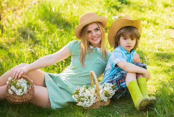 My family is my inspiration. mother having fun with her kid. Portrait of happy mother and son. Happy family. Positive human emotions. feelings of joy. pick summer flowers in park. Family relationship