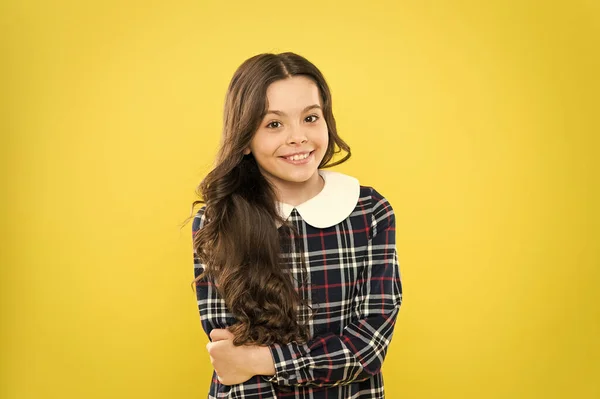 Glamour girl model. real beauty. Small scottish girl. stylish school uniform for kids. be fashionable everyday. happy childhood concept. little fashion model yellow background. her hair is perfect — Stock Photo, Image