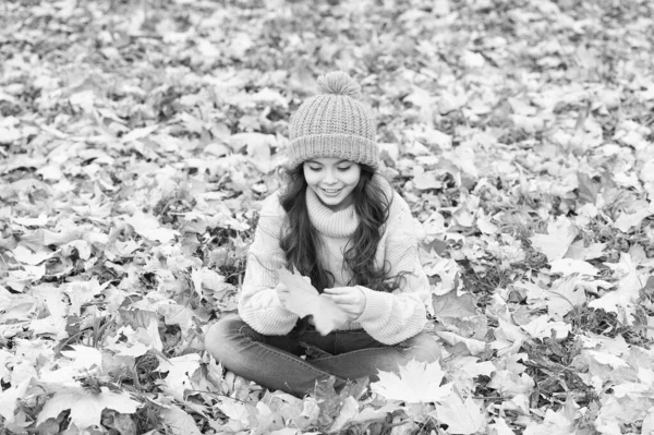 November is here. Child in yellow hat outdoors. Hat keep warm. Kid wear warm soft knitted hat. Warm woolen accessory. Girl long hair happy face nature background. Keep you warmest this autumn — Stock Photo, Image