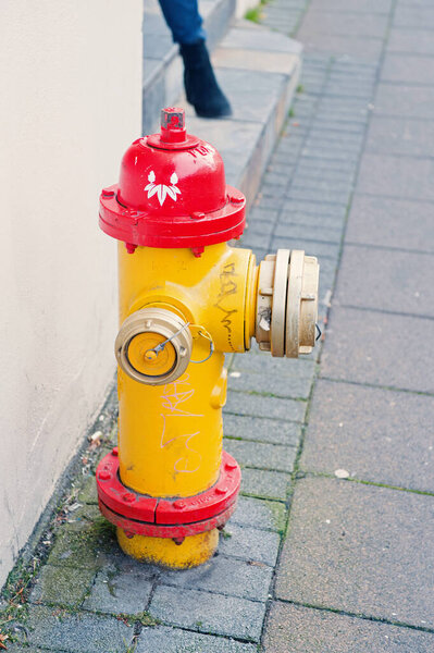 Yellow fire hydrant in street reykjavik iceland. Fire hydrant also called fireplug can tap into water supply. Active fire protection concept. Bright hydrant in grey street scandinavian country