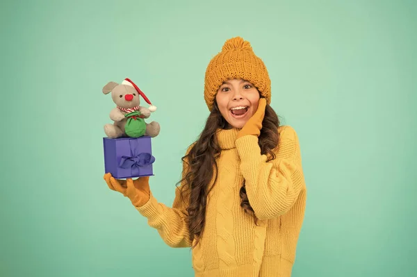 Appease with gift. Shopping tips. Rat symbol of year. Happy girl hold mouse toy and wrapped gift box. Kid knitted sweater and hat play plush toy. Shop for kids. Happy 2020 year. Gift for good luck