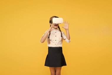Yeni teknolojileri test ediyoruz. Gelecekteki eğitim. Okula dönüyorum. Dijital gelecek ve yenilik. Sanal gerçeklik. VR kulaklıklı kız. Küçük çocuk kablosuz sanal gerçeklik gözlüğü takıyor. Mutlu çocuk modern teknoloji kullanıyor.