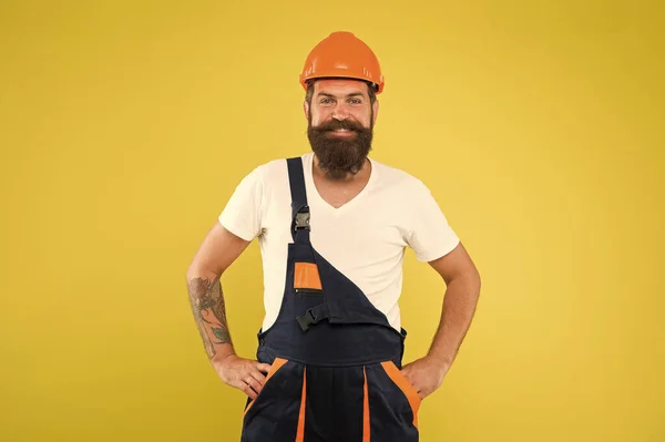 excited repairer. expert in building. brutal male worker with beard. he is just artisan. choose your occupation. construction engineer in work uniform. man builder in hard hat. wear helmet for safety