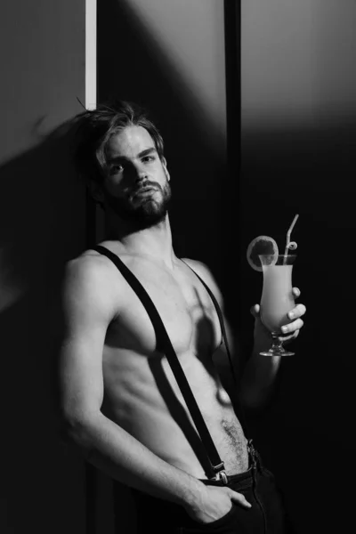 handsome muscular man with cocktail