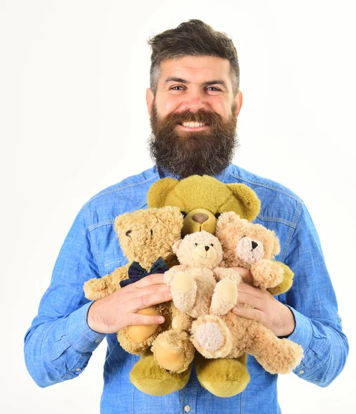 Guy with beard hugs soft toys with tenderness. — Stock Photo, Image