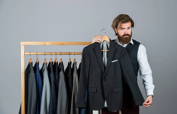 The future of fashion. Male fashion designer. Individual measures hand of man. Man ordering business suit posing indoor. Tailor measures man. stylish business man at workspace. Fashion design studio