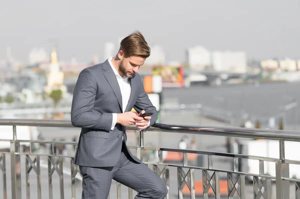 Byznysmen s chytrým telefonem na terase ve městě, obchodní komunikace — Stock fotografie