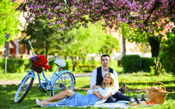 Romantic picnic. Couple cuddling on blanket. Happy together. My darling. Anniversary concept. Idyllic moment. Man and woman in love. Picnic time. Spring date. Playful couple having picnic in park — Stock Photo, Image