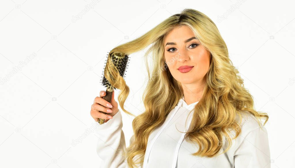 Professional equipment. Pretty woman brushing hair isolated on white. Long hair. Hair care. Hairdresser salon. Easy hairdo. Beauty supplies. Bristles perfectly untangle curly hair. Hot curling brush