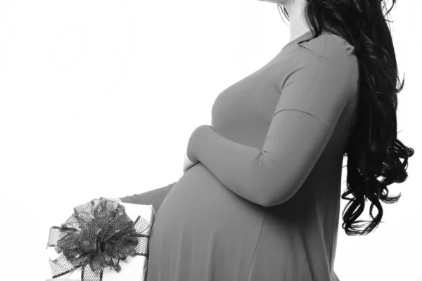 Vrouwelijke handen van zwangere vrouw houden aanwezig of geschenk — Stockfoto