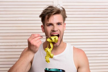 Heyecanlı yüzlü maço kaseyi mezuralarla tutuyor.