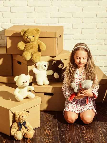 Convenience meets luxury. happy child cardboard box. purchase of new habitation. playing into new home. new apartment. Cardboard boxes - moving to new house. happy little girl with toy — Stock Photo, Image