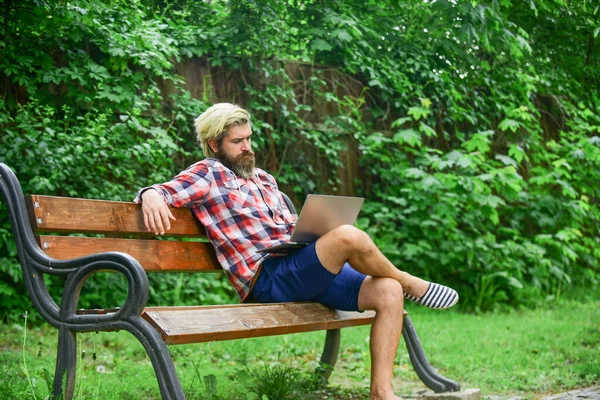 Work and relax. Working online. Hipster inspired work in park. Agile business. Bearded guy sit bench park nature background. Modern laptop. Remote job. Fresh air. Mobile internet. Online shopping