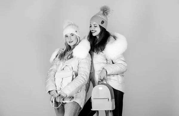 fit them just right. flu and cold. seasonal shopping. winter clothing fashion. down jacket. winter holidays. Students friendship. girls in beanie with leather bag. women in padded warm coat. xmas
