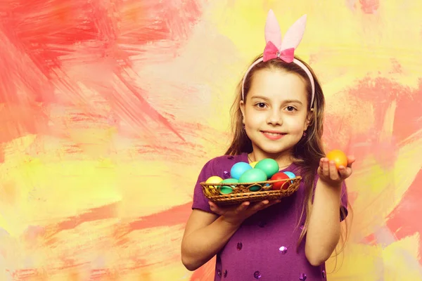 Small happy baby girl holding pottle with easter eggs — Stock Photo, Image