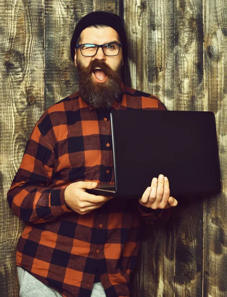 Brutalny, biały hipster trzymający laptopa — Zdjęcie stockowe