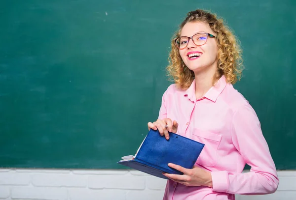 Teacher best friend of learners. Woman school teacher in front of chalkboard. Passionate about knowledge. Pedagogue hold book and explaining information. Education concept. Teacher explain hard topic