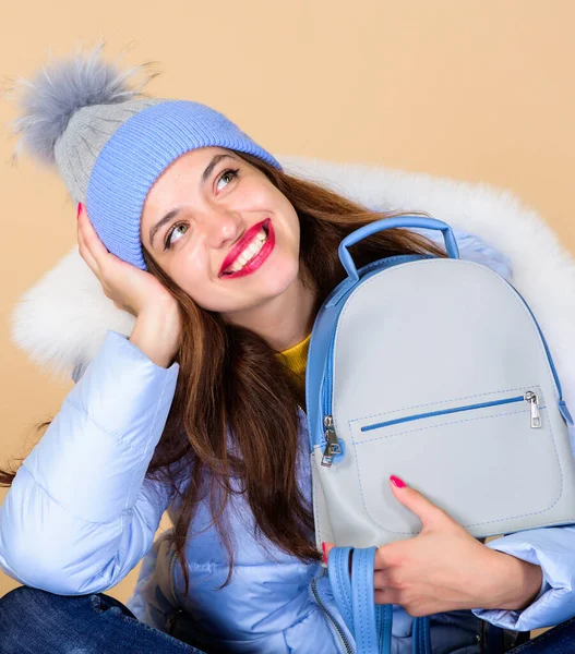 perfect smile. flu and cold season. Leather bag fashion. warm winter clothing. shopping. happy winter holidays. girl in puffed coat. faux fur fashion. woman in beanie hat with backpack