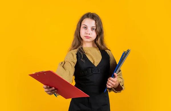 this is for you. paperwork concept. ready for lesson. prepare for exams. kid study well. teen girl hold folder with documents. back to school. kid presenting project. child is working with paper