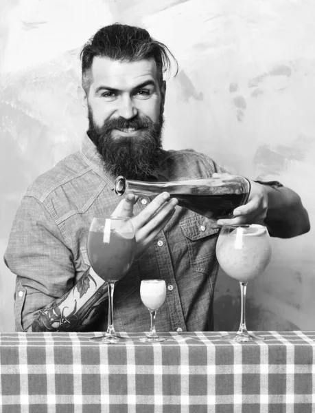 Brutal caucasian hipster with alcoholic cocktails and bar stuff