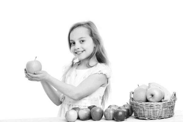 Cute baby girl with colorful fruits in basket — Stock Photo, Image