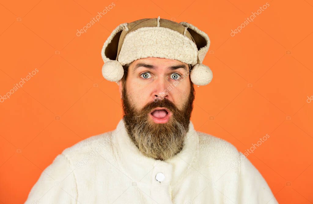 Before Christmas. portrait of trendy guy wearing hat. Male winter style. Modern winter earflap beanie hat. Funky surprised bearded man. mature man posing with funny outfit. man beard in winter hat