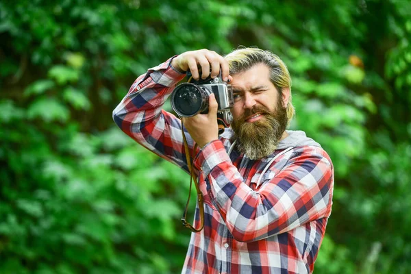 Photography in modern life. Hobby and professional occupation. Photographer use vintage camera. Man with retro camera. Camera settings concept. Find perfect angle. Bearded man hipster taking photo — Stock Photo, Image