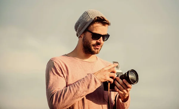 Réglages manuels. Guy photographe en plein air ciel arrière-plan. Un reporter de Hipster qui prend des photos. Concept de photojournaliste. Blogueur de voyage. Photographe professionnel. Beau photographe gars appareil photo rétro — Photo