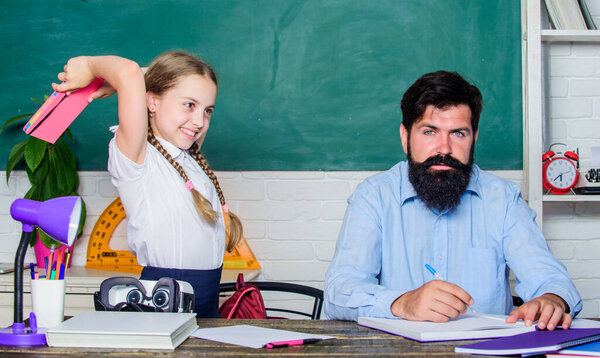 Study is fun. School teacher and schoolgirl. Homeschooling with father. Reward and punishment principle. Help study. Discipline and upbringing. Man bearded pedagogue study together with kid