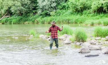 Hobi, zamanın eğlencesidir. Yaz haftasonu. Başarılı sinek avcılığı. Olgun adam balık tutuyor. Balık tutan adam. Sudaki sakallı balıkçı. Balıkçılar olta kullanma tekniğini gösteriyor. hobi ve spor aktivitesi