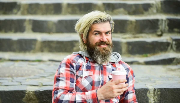 his perfect breakfast. take away coffee. good morning inspiration. brutal man with beard drinking tea from cup. bearded man drink coffee outdoor. hipster relax on stairs. mature traveler having rest