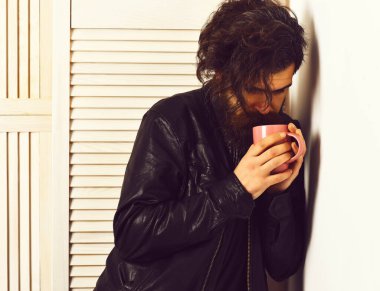 Kafkasyalı vahşi hippi elinde bardak ya da kupa tutuyordu.