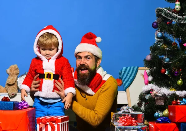 Christmas family plays together on blue background.