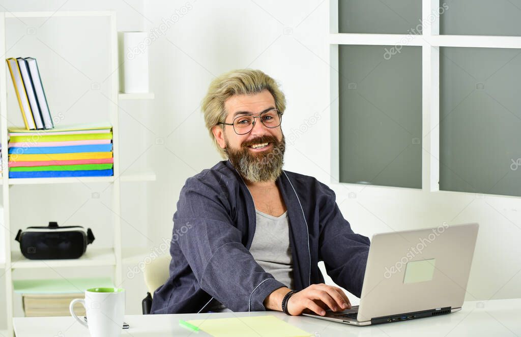 Enjoying good working day. Workplace with laptop on table at home. lazy sedentary lifestyle. male working from home office. man typing on computer. man at workplace use technology. Working Freelance