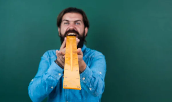 learning the subject. selective focus. size concept. man with beard using ruler. studying the measurement. formal education. male student at mathematics school lesson. pass the math exam