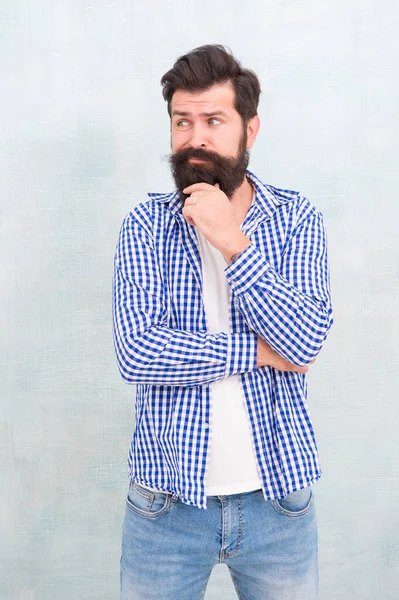 Pensativo hipster brutal con el pelo facial sin afeitar en el estilo casual fondo azul, barba — Foto de Stock